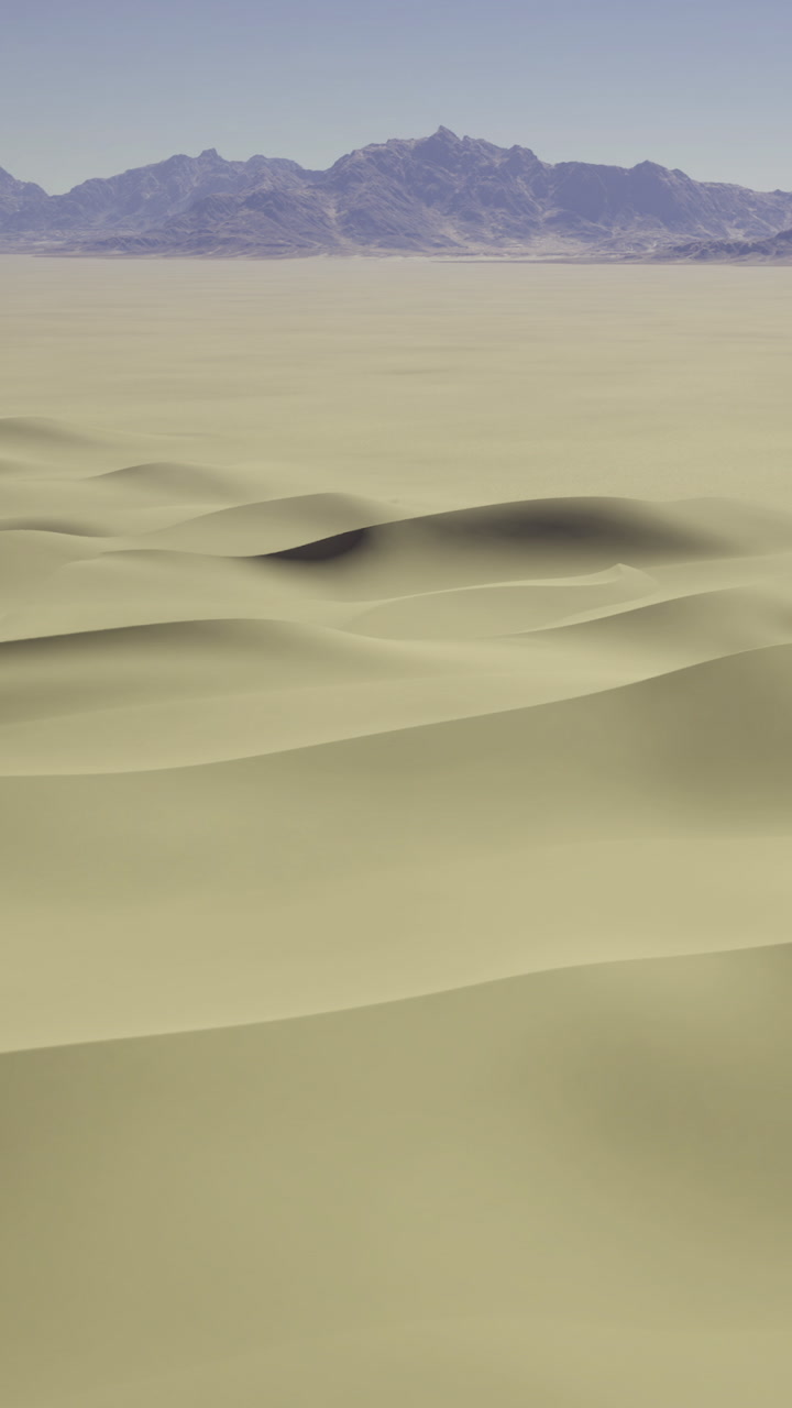 Waves of sand stretch endlessly beneath a soft blue sky