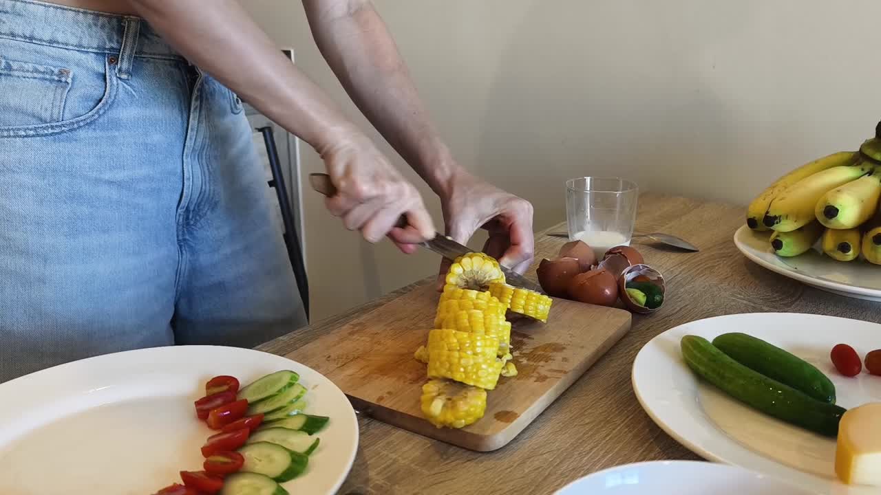 Preparing a healthy meal with corn, bananas, and vegetables
