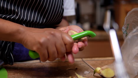 Peeling-fresh-ginger-to-add-to-a-homemade-recipe---slow-motion