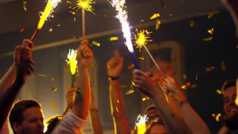 dancing with sparklers in confetti shower