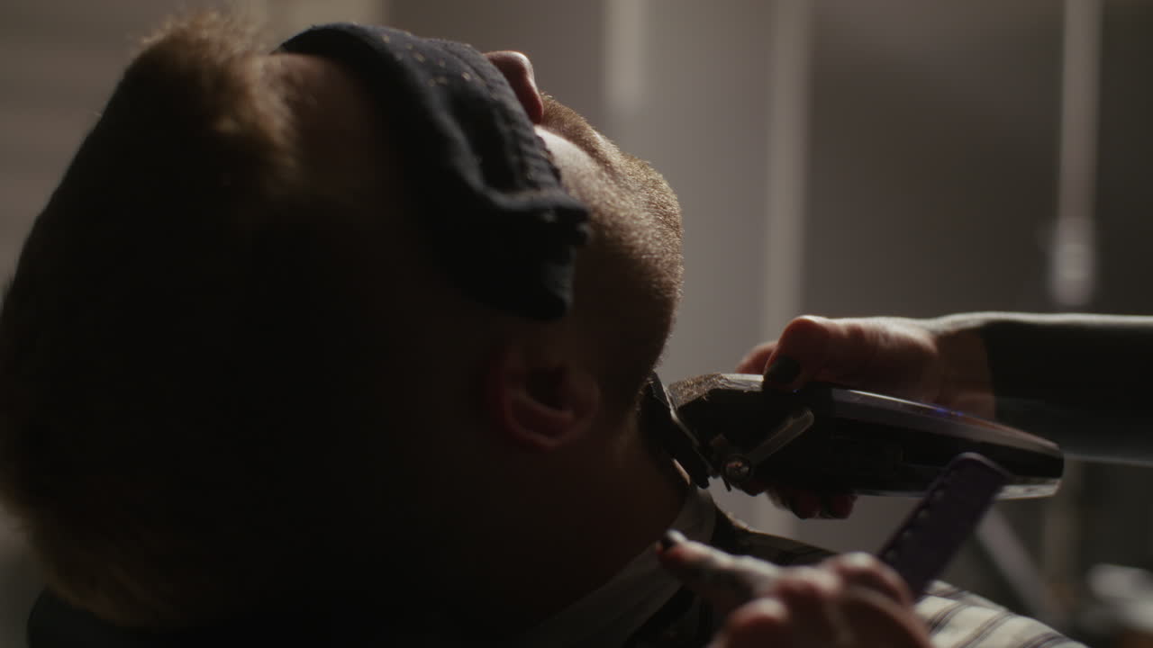 Man Getting a Haircut and Beard Trim at a Barber Shop