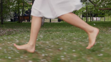 woman running barefoot in a park