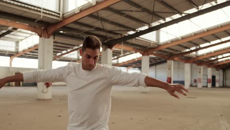 Male-dancer-in-an-empty-warehouse