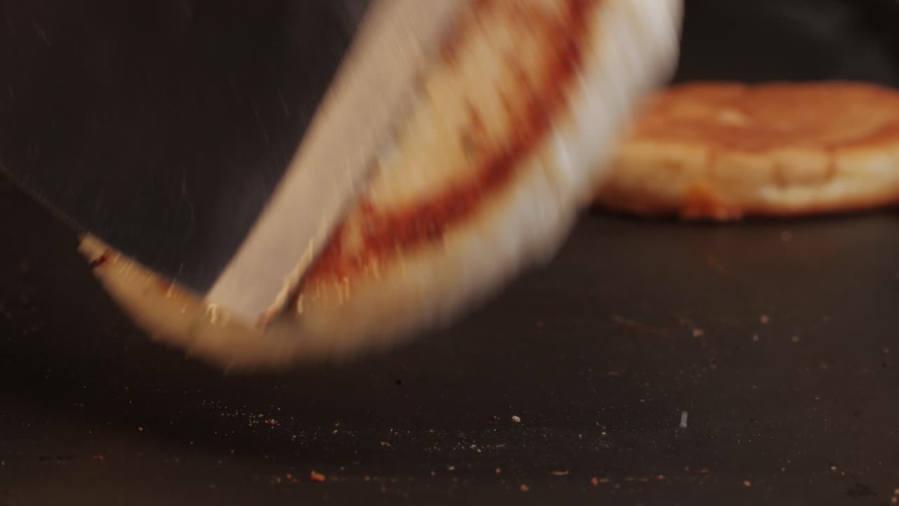 Cooking American fat smash burger on grill close-up. Chiken or fish cutlet smashing by burger press. The chef in kitchen of the restaurant making cutlets for burgers - smash burger beefsteak. Fast and street food concept. High quality 4k footage