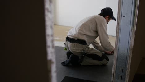 man installing new flooring