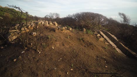 Estepona-coastline-and-entrance-to-abandoned-bunker,-pan-right-view