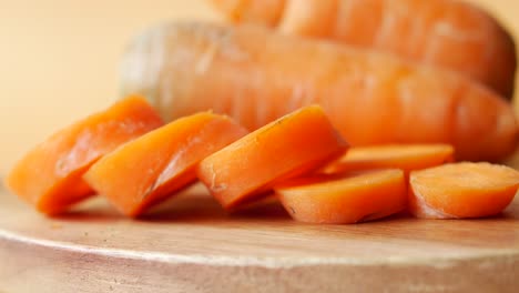 close-up of sliced carrots on a wooden board