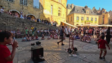 crowd enjoys a lively street performance