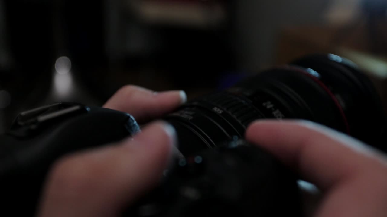 Rotating Zoom Ring And Pressing Shutter Button Of A DSLR Camera - close up