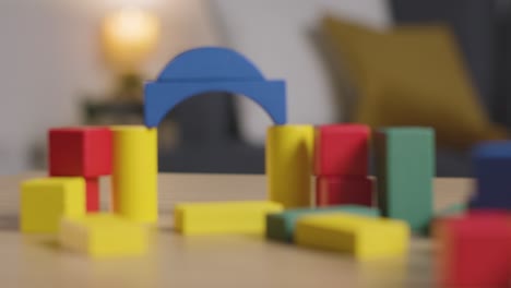 colourful wooden building blocks on table at home for learning and child diagnosed with asd 6