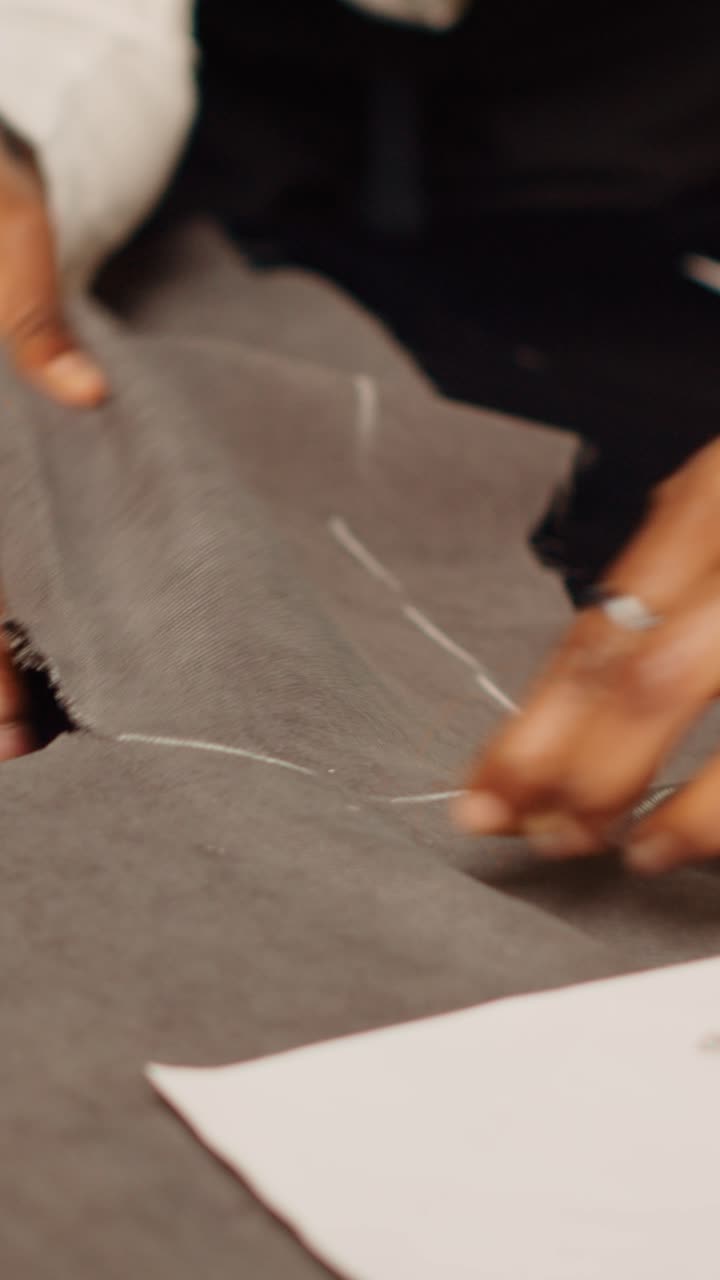 Vertical video Team of tailors cutting material