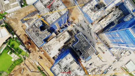 top down aerial view over construction site of high-rise buildings