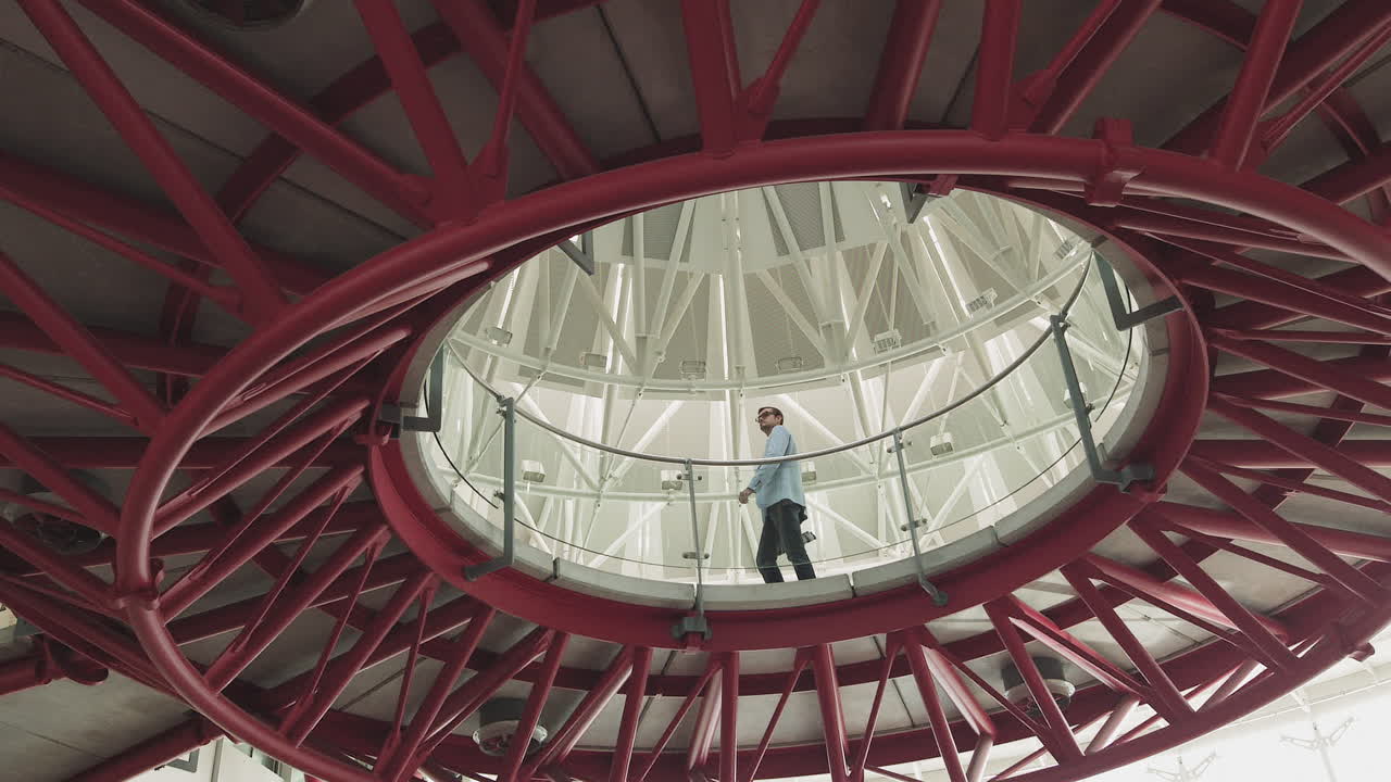 Handsome stylish man with glasses the architect walks through the modern office of the castle from