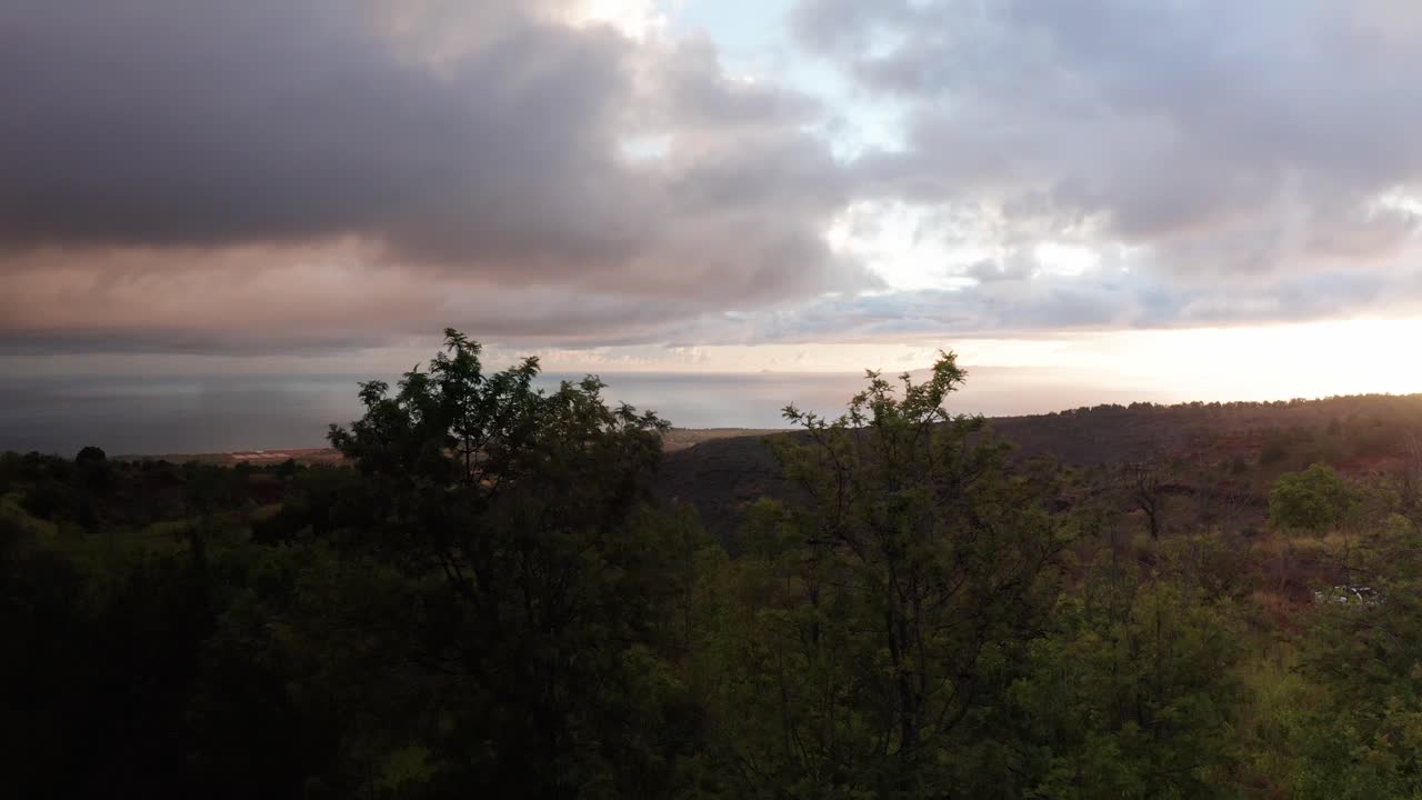 Low panning aerial shot of the Forbidden Island of Ni'ihau at sunset off the coast of Kaua'i in Hawai'i