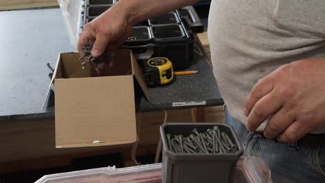 man sorting - organizing screws
