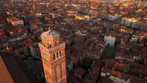 venice italy aerial view at cathedral church cusp and city at dusk time, warm summer feeling with adriatic sea horizon, european travel destination