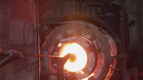 hot glass being molded in a furnace in slow motion