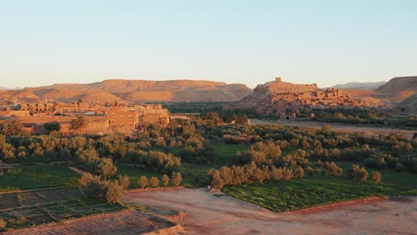 wide view of ait ben haddou fortress and desert landscape during sunrise in morocco