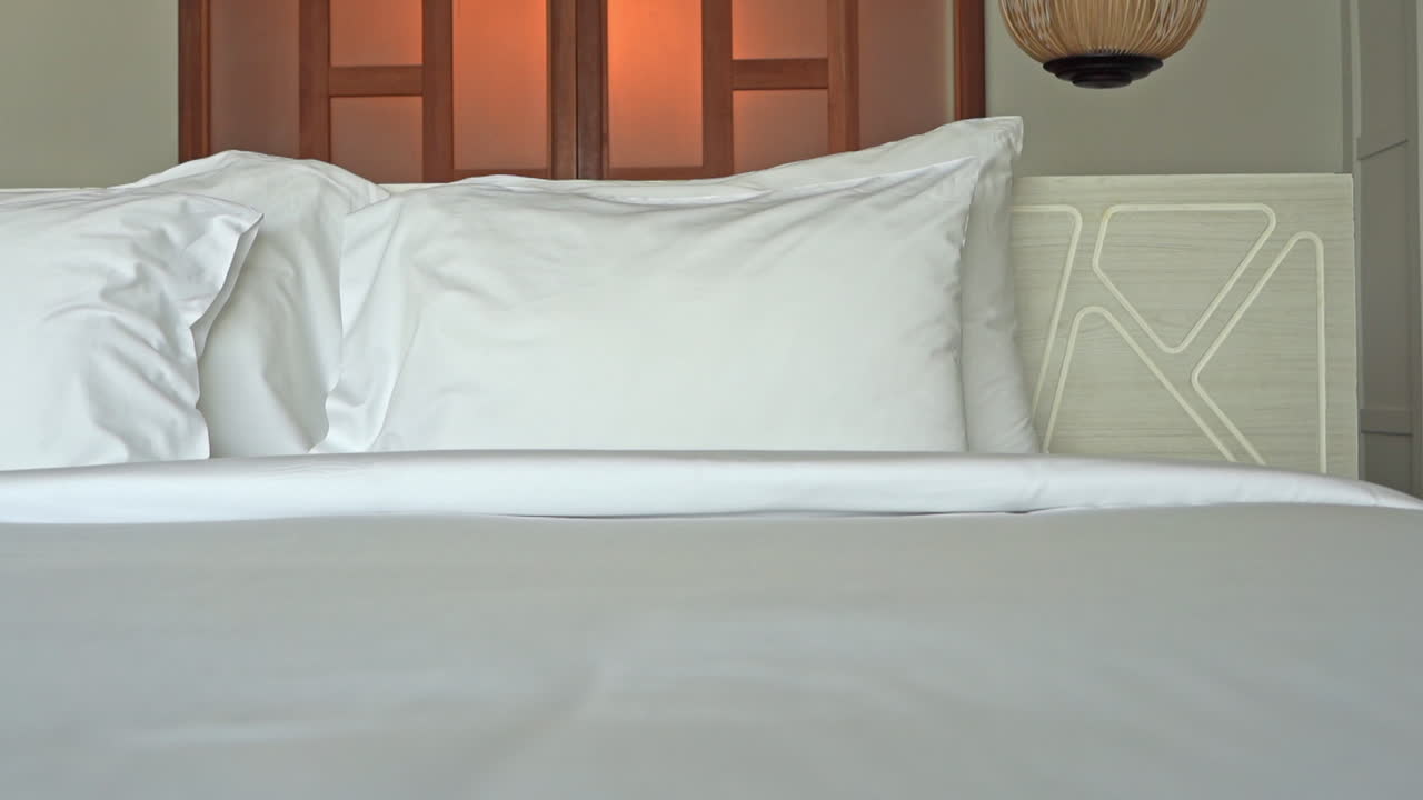 Tilt-down from a geometric headboard to the foot of the bed