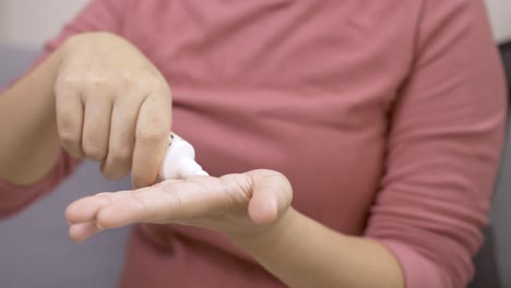 woman applying hand cream for healthy skin routine