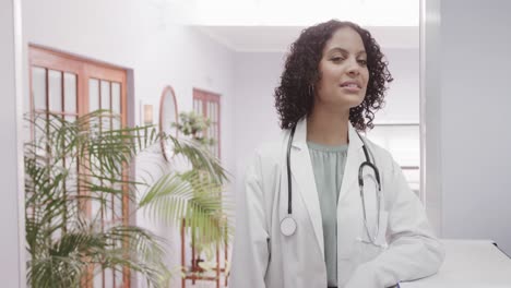 Portrait-of-biracial-female-doctor-wearing-lab-coat-and-stethoscope,-copy-space,-slow-motion