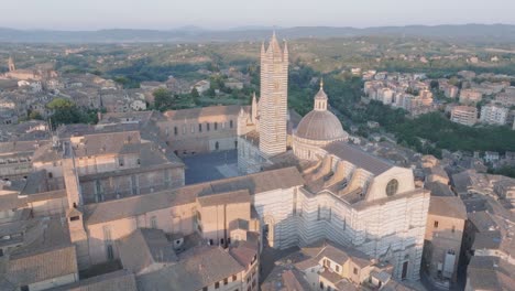 aerial view of siena, tuscany, italy at sunrise with duomo di siena and medieval town in 4k