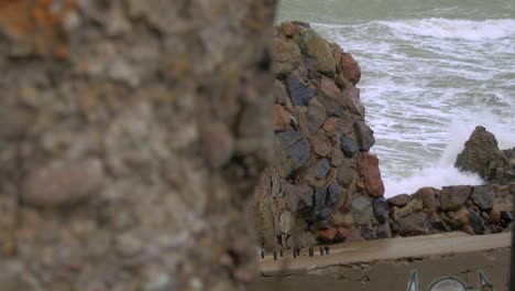 Big-waves-hitting-the-abandoned-concrete-coast-defense-building-ruins-in-stormy-weather