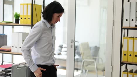 woman in office looking down by shelves