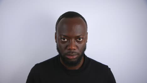 Black-Male-Staring-Angrily-Into-Camera-With-White-Background