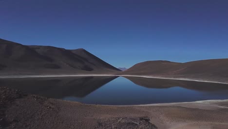 lake miniques lake and a volcano in chile at the foot of cerro miscanti volcano, bolivia