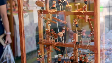 wooden figures in motion at a market display