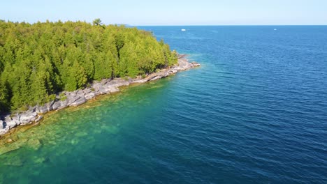 Aerial-of-white-pine-over-Georgian-Bay-clear-water-in-Ontario,-Canada