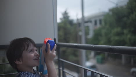 Footage-of-a-little-caucasian-boy-playing-with-a-water-gun-toy