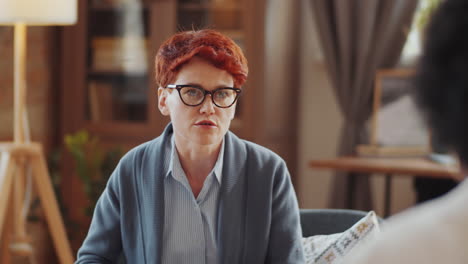 female psychologist consulting patient on therapy session