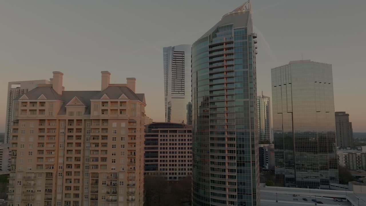 Buckhead district uptown commercial and residential skyline glass buildings at sunset, Atlanta, Georgia, Drone shot