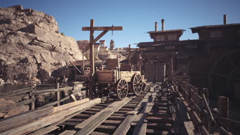 desert town with wooden wagon on tracks in daylight