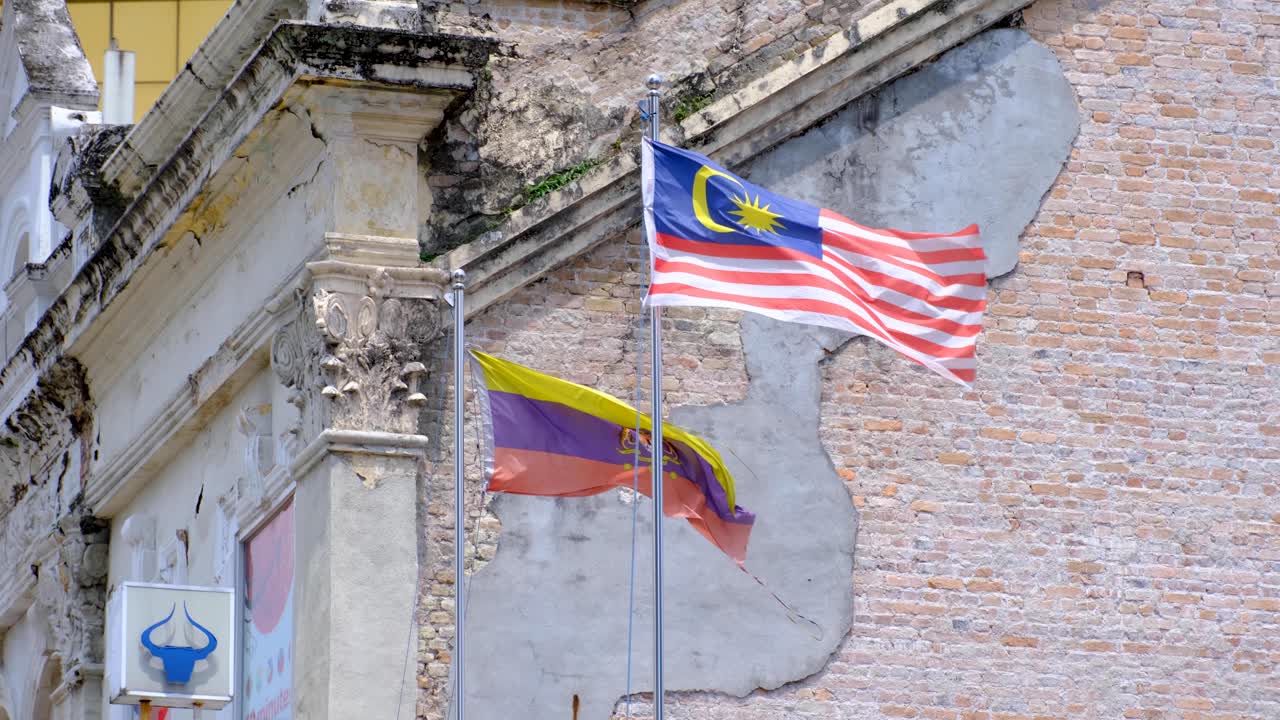 The flag of the Federal Territories of Malaysia, and the Malaysian flag, flying in the capital city of Kuala Lumpur Malaysia