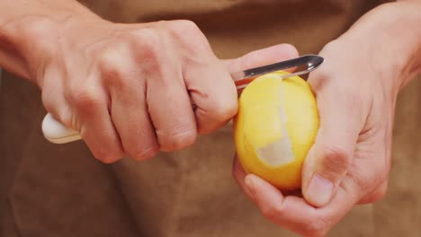 bartender makes a cocktail in a glass with orange peel. high quality 4k footage