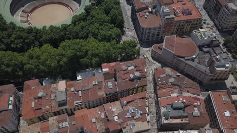 Aerial-street-Pamplona-Spain-running-with-the-bulls,-tilt-to-bull-ring