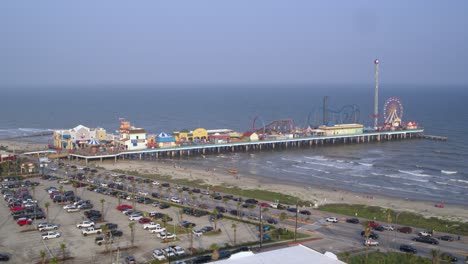 Drone-view-of-the-Pleasure-Pier-and-Galveston-Beach-in-Galveston,-Texas