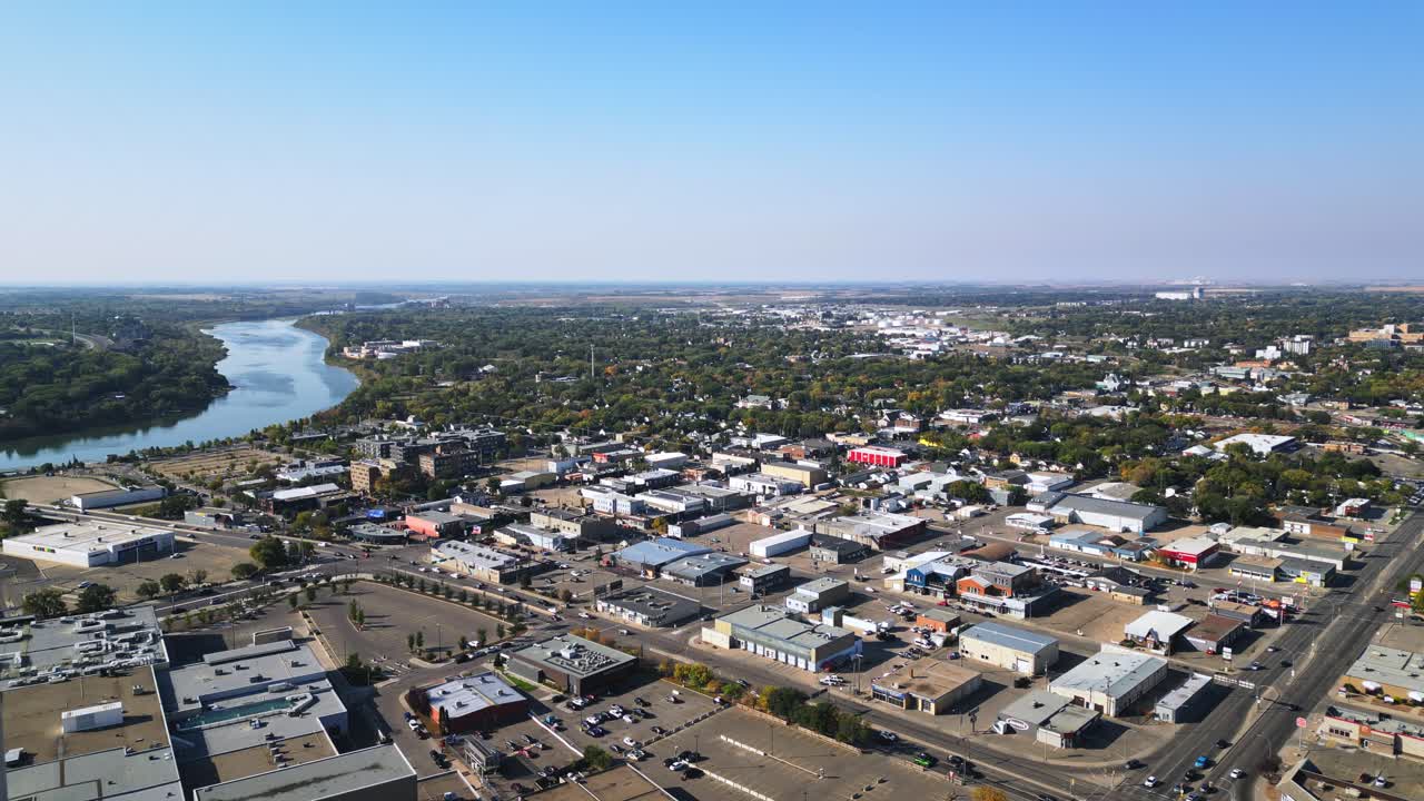 Aerial shows southern Saskatoon riverfront with new developments in autumn