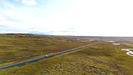 Stunning-wild-scenic-landscape-Iceland-road-travel-vehicle-drive,-aerial-view