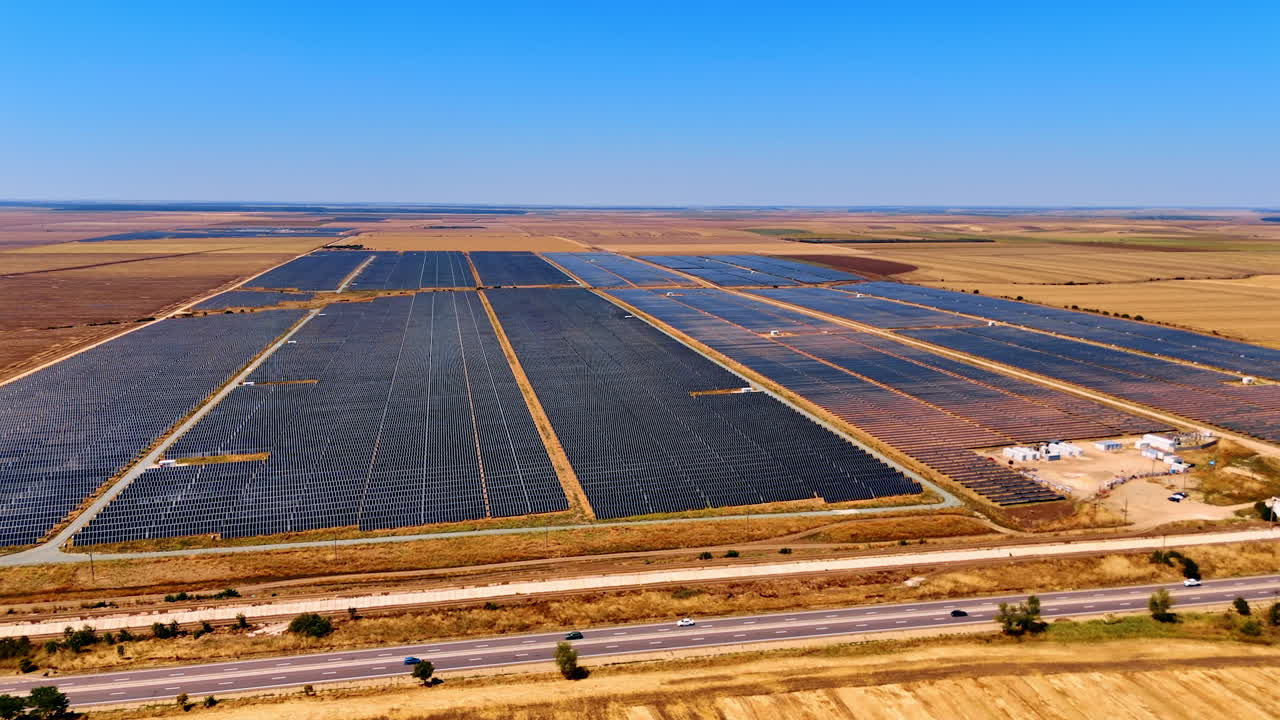Solar farm in vast open landscape. Vast solar panels stretch across an open landscape under a clear blue sky, showcasing renewable energy production