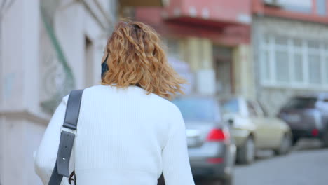 woman walking down a city street