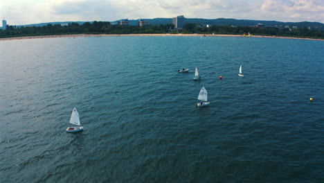 aerial view of optimist dinghy boats sailing on the baltic sea at sunny vacation day