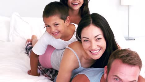 Cute-family-playing-on-the-parents-bed