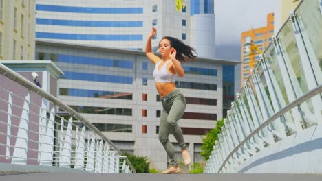 Beautiful-young-ballerina-practicing-dance-on-the-bridge-in-the-city-4k