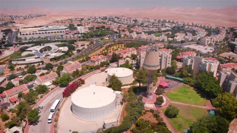 aerial view of a desert town with a prominent water tower and residential neighborhoods