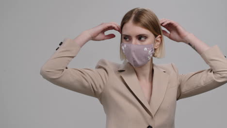 beautiful woman in stylish face mask dancing