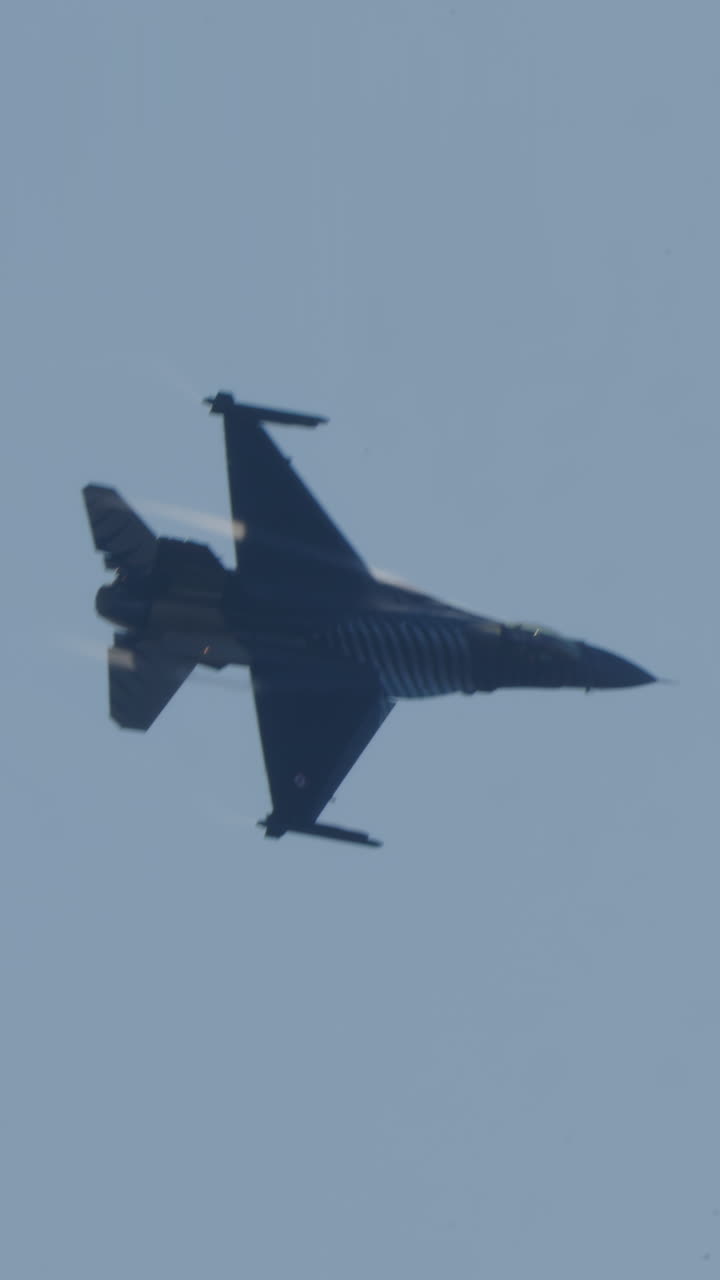 Powerful F-16 Fighter Jet Soaring Through Clear Blue Sky